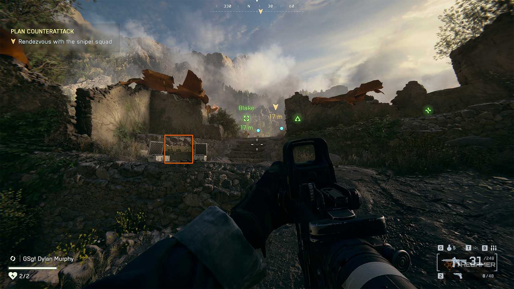 Battlefield 6 player looking up a hill, with an ammo crate to the left highlighted by an orange square.