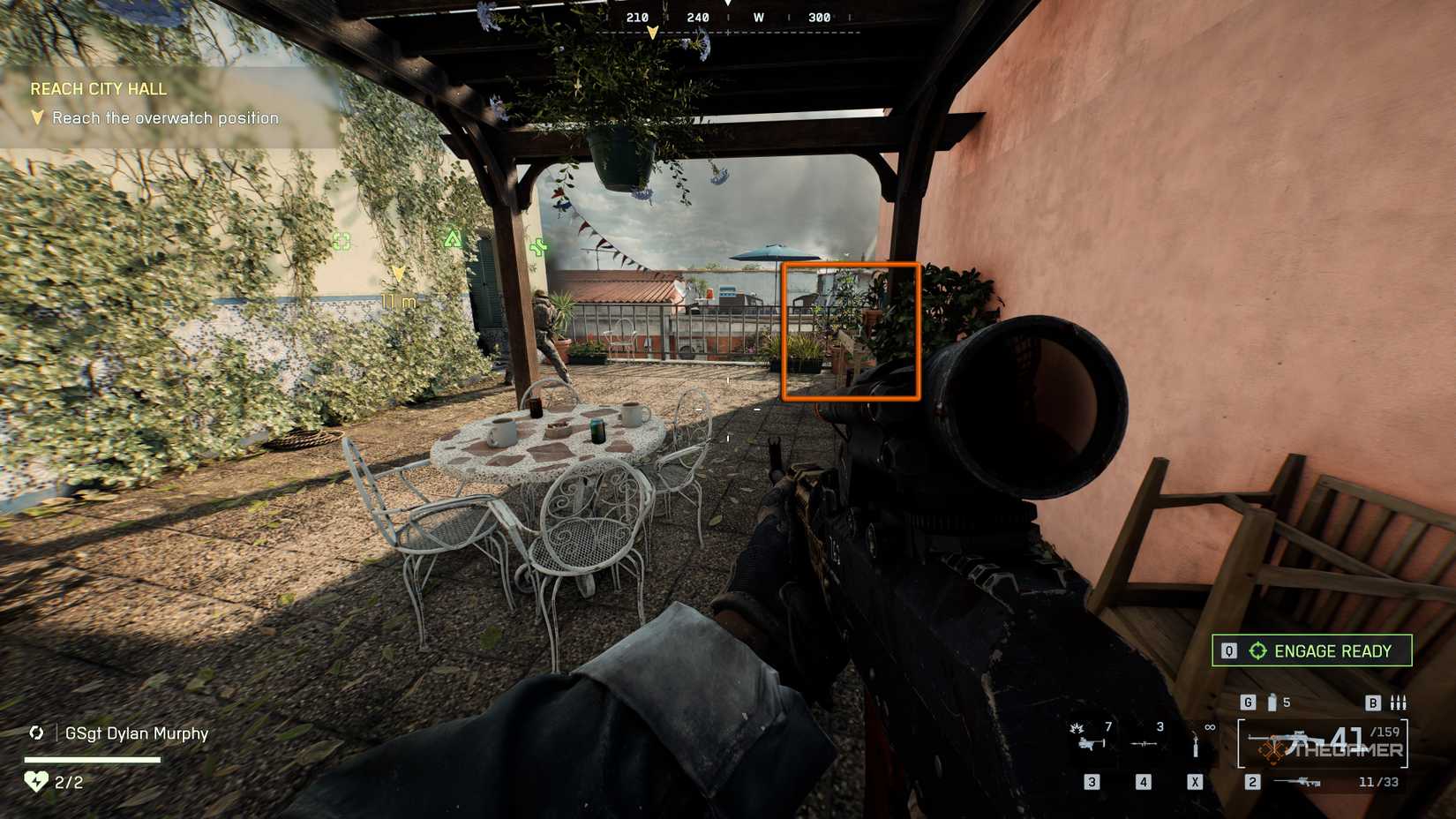 Battlefield 6 player on a balcony, ahead of a table for four with abandoned coffee mugs. A table further up is highlighted by an orange square.