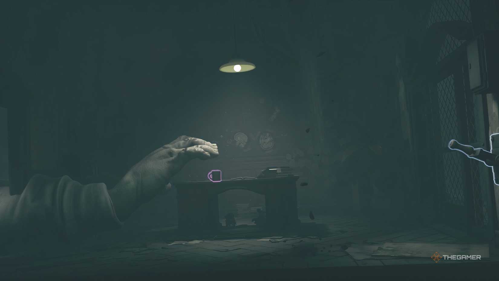 Low and Alone hiding from a hand in Little Nightmares 3.