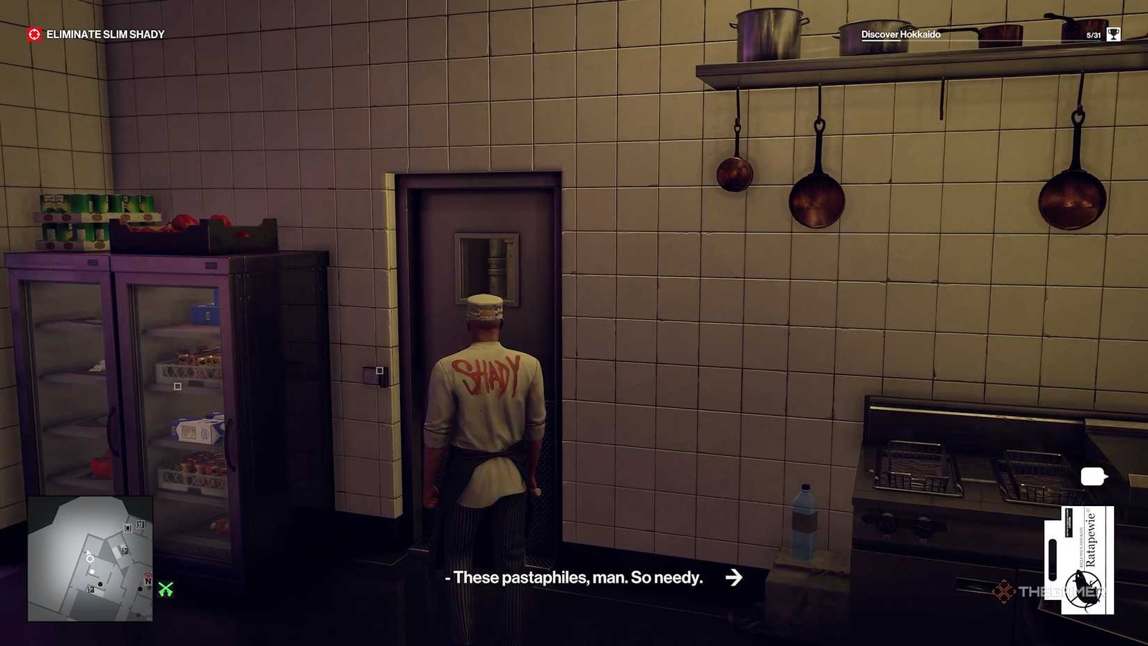 Agent 47 by the freezer door in Hitman World of Assassination.