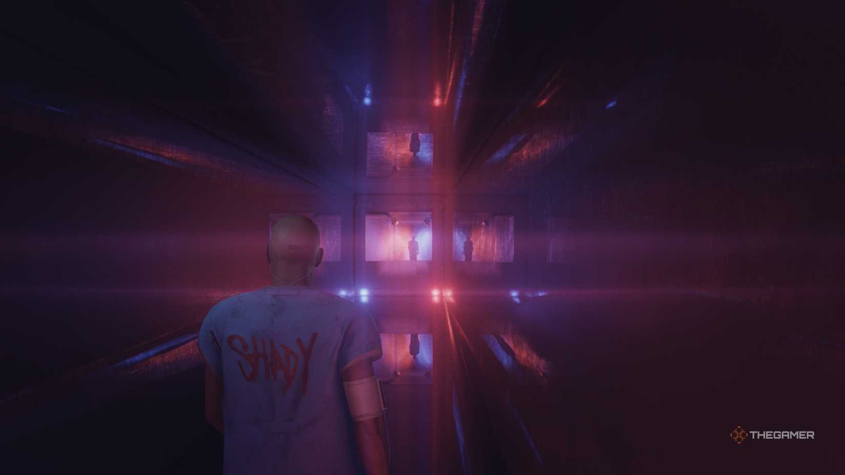 Agent 47 in a strange place, looking at a mirror in Hitman World of Assassination.