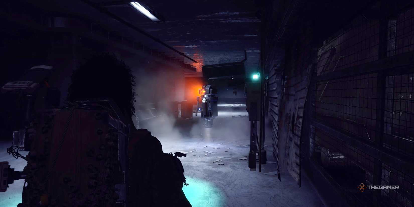 Player raider backing away from a Shredder on alert in the dark at the Loading Bay Metro Station in Arc Raiders.