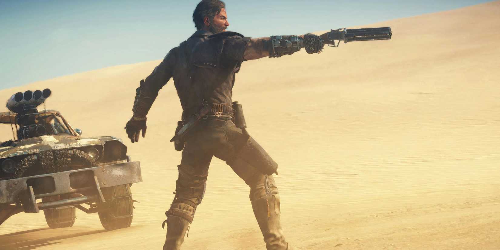 Main character Max Rockatansky points his gun at something in the desert in Mad Max.